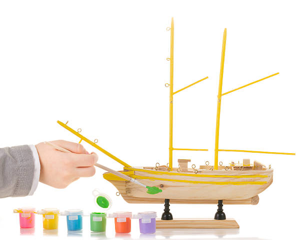 Model sailing ship Boy paints model sailing ship assiduity stock pictures, royalty-free photos & images