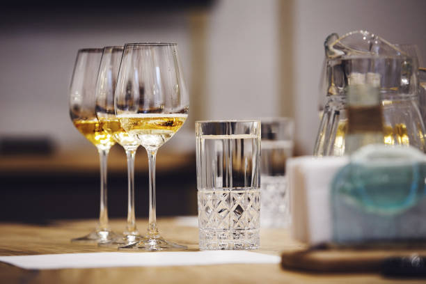 istock Few full wine glasses with white wine on the table, close up. Serving, service in restaurants. 1785531561