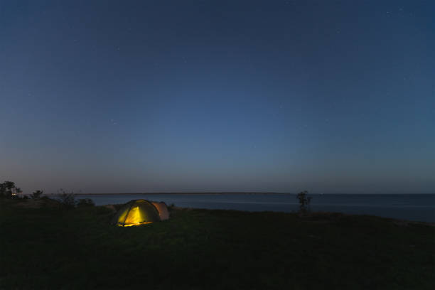 istock Wild camping with a tent at night in summer. Starry sky, Paldiski cliff. 1785531566