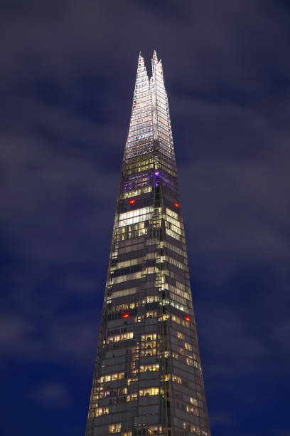 The London Shard at Night The illuminated upper levels of the London Shard Building, London Bridge, UK the shard close up stock pictures, royalty-free photos & images