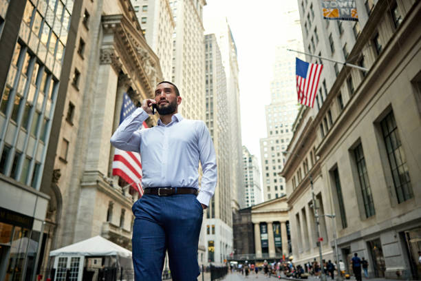 istock Wall Street trader using phone outdoors 1785534794