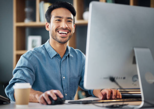istock Computer, research and business man in office working online for information technology, internet or global digital company. Asian person or worker planning, reading or editing report on desktop pc 1785535392