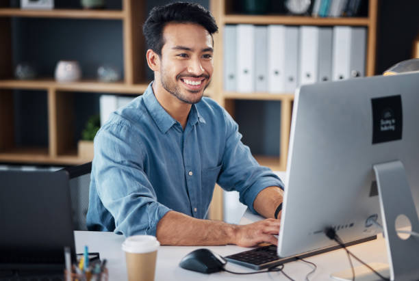 istock Computer, typing and business man in office working online for information technology, internet or global digital company. Happy Asian person or worker on desktop pc for professional market research 1785535402