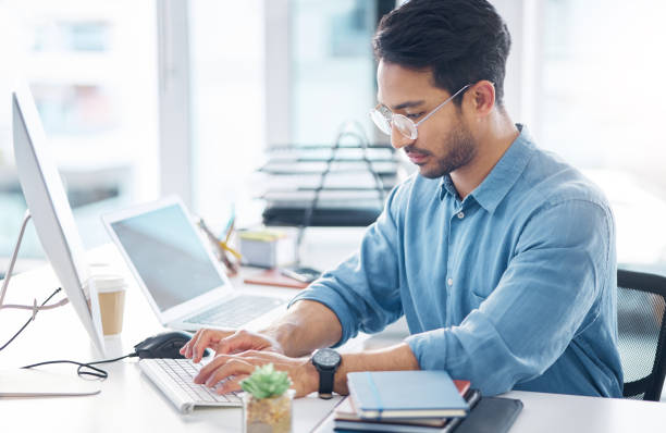istock Serious, business man and typing on computer in office for startup management, planning and agency. Focused male worker at desktop technology for online project, website or internet research at table 1785535674