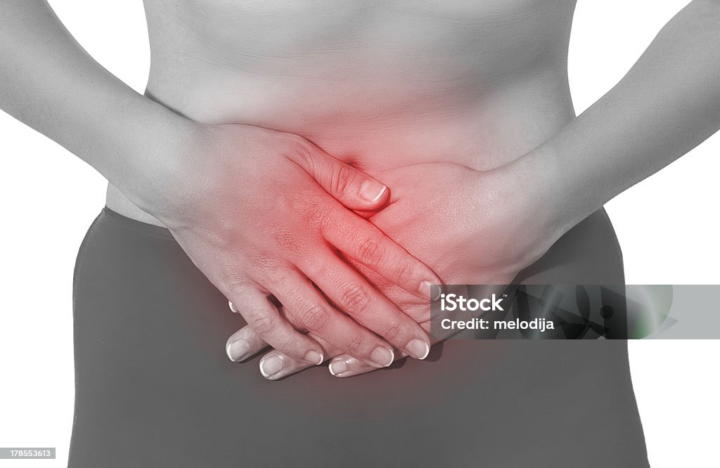 Acute pain in a woman stomach Adult Stock Photo