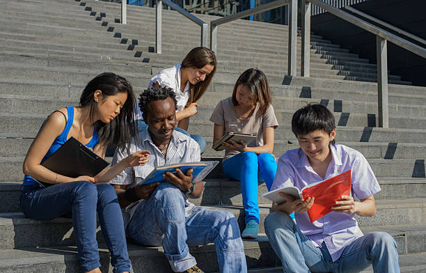 istock Multiethnic group of university students sitting on steps 178553635