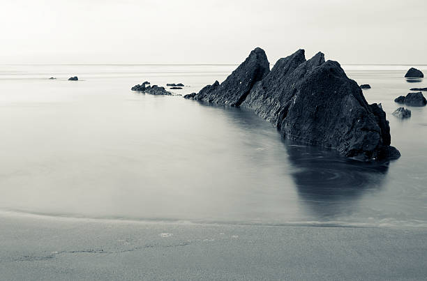 peaks shaped rock in the sand of Barrika beach peaks shaped rock in the sand of the Barrika beach, Basque Country sopelana stock pictures, royalty-free photos & images