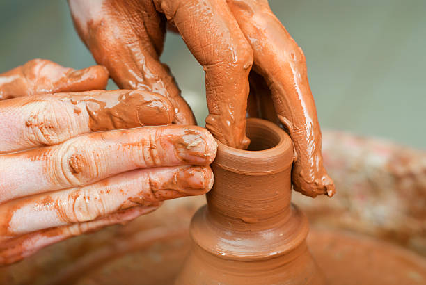 istock hands of a potter, creating an earthen jar 178554030