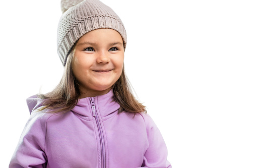 Portrait of the child in warm clothes and a hat isolated on the white background