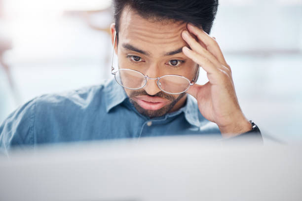 istock Asian man, frustrated and tired with laptop in office for glitch, problem or anxiety for proposal, idea or burnout. Businessman, computer and thinking with stress, depressed or headache for 404 error 1785543028