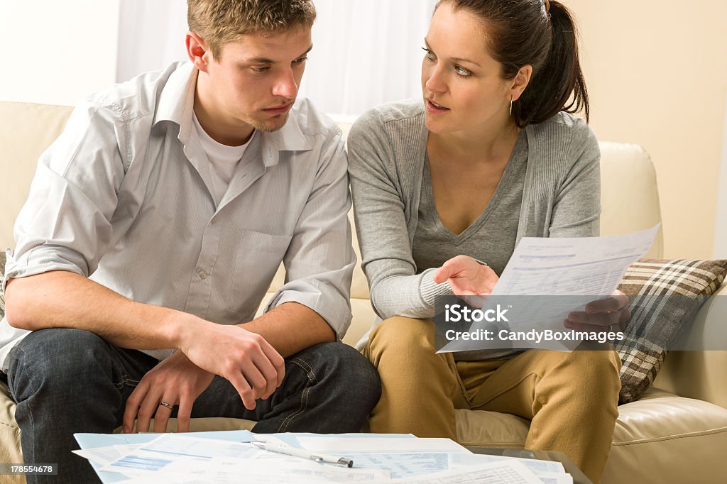 Worried couple talking about their expenses Worried couple talking about their expenses and financial problems Adult Stock Photo