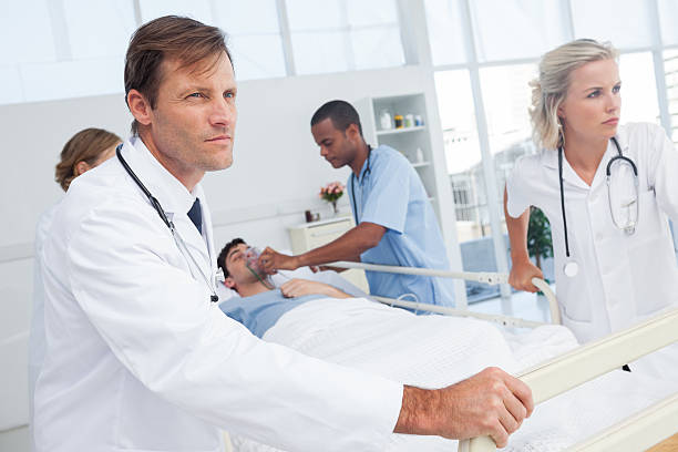 istock Doctors pushing the bed of a patient 178555111