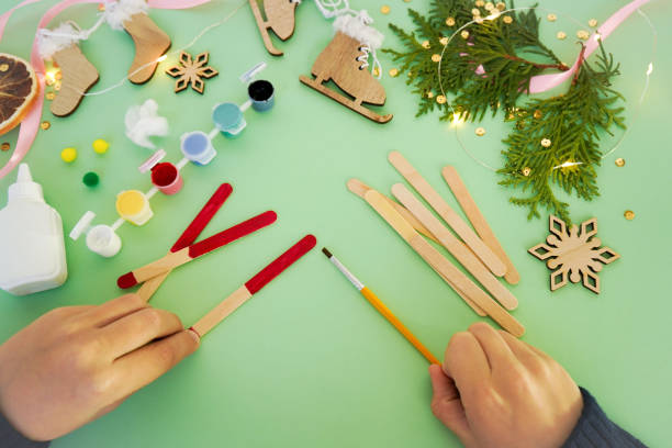 istock Step by step instruction how to make christmas toy from ice cream sticks. Step 2 painting sticks red. Children's New year handmade craft 1785551810