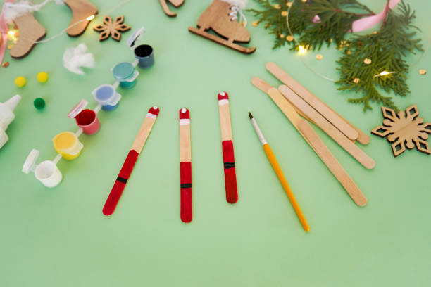 istock Step by step instruction how to make christmas toy from ice cream sticks. Step 3 painting sticks red. Children's New year handmade craft 1785551813