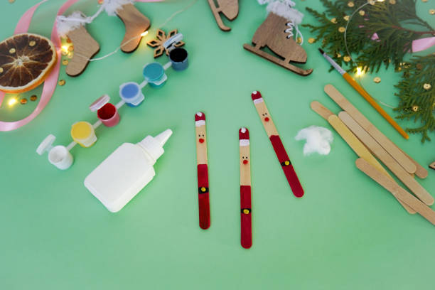 istock Step by step instruction how to make christmas toy from ice cream sticks. Step 4 with the help of plasticine balls, we make a nose, eyes and a Santa Claus belt. Children's New year handmade craft 1785551828