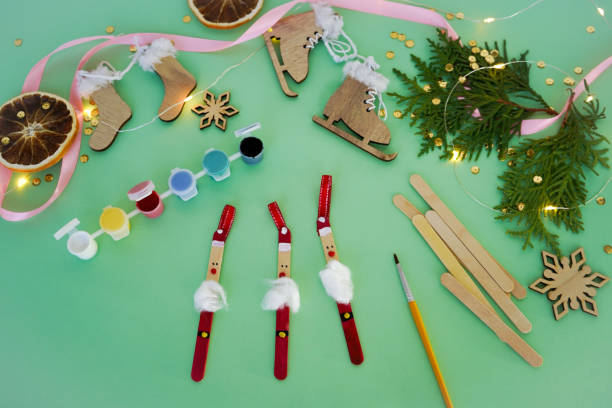 istock Step by step instruction how to make christmas toy from ice cream sticks. Step 5 glue a beard made of cotton wool Santa Claus. Children's New year handmade craft 1785552360