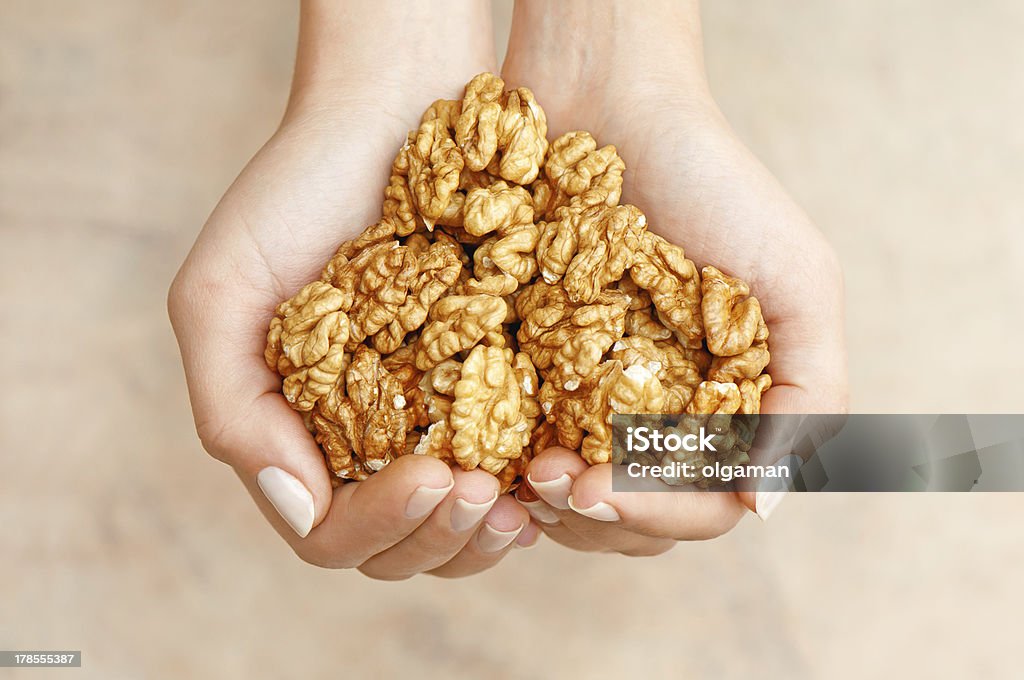 Lovely nutes Walnuts in woman hands forming heart shape Heart Shape Stock Photo