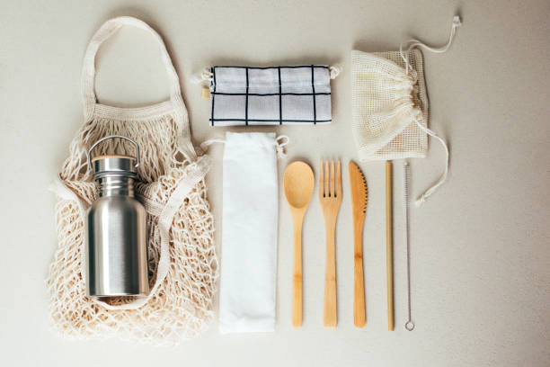 istock Different fabric bags for storage on a gray background. Eco bags for multiple use. A reusable straws, wooden cutlery 1785565334