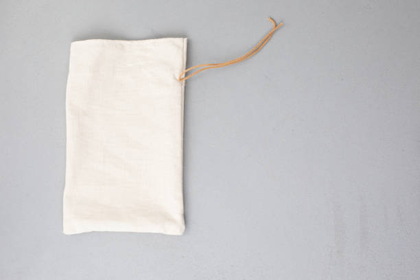 istock Beige fabric bag for storage on a gray background. Eco bags for multiple use, conscious consumption 1785565832
