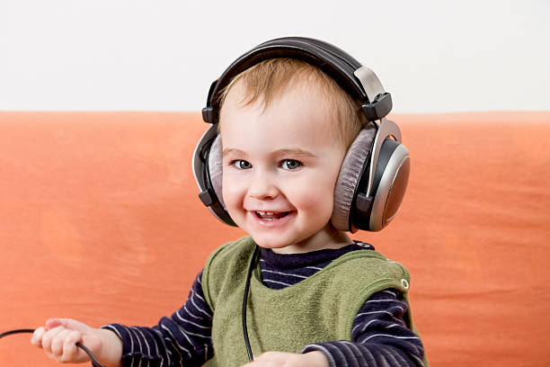 istock young child on couch with headphone 178557153