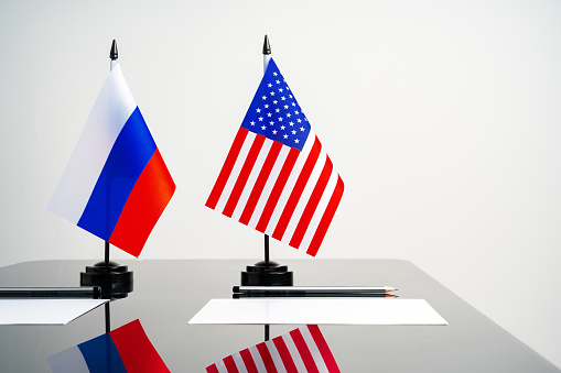 Flags of Usa and Russia on negotiation table close up