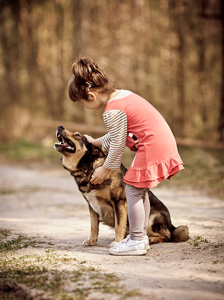 istock Little girl playing with dog 178557294