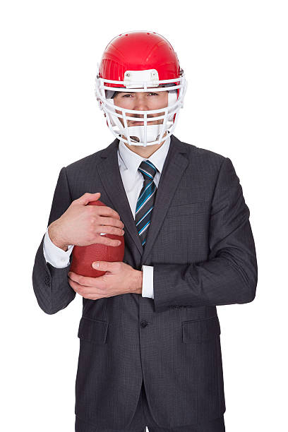 istock Competitive businessman playing american football 178557399