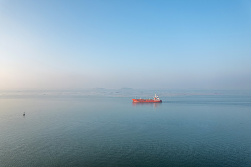 A bird's-eye view of an oil tanker traveling in the sea
