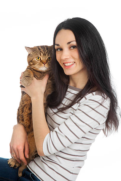 istock beautiful smiling brunette girl and her ginger cat 178558748