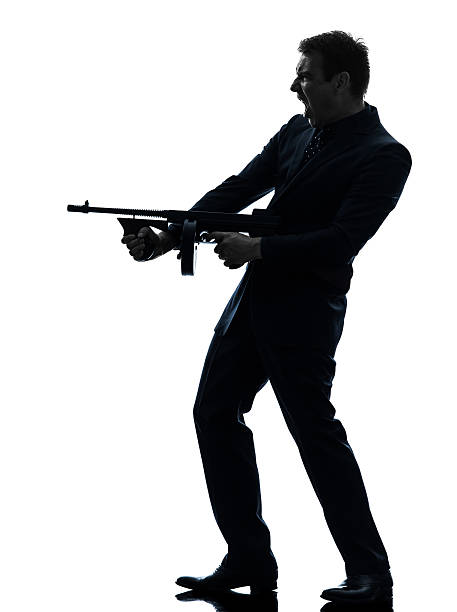 istock gangster man holding thompson machine gun silhouette 178559042