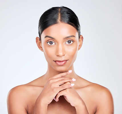 Beauty, skincare and portrait of Indian woman with makeup, glow and cosmetics on white background. Dermatology, spa and face of isolated person for wellness, glamour and facial for salon aesthetic