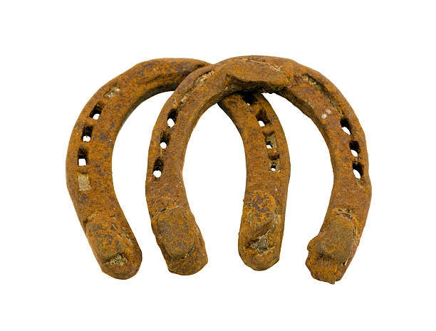 istock Retro rusty pair of horseshoes isolated on white 178559563