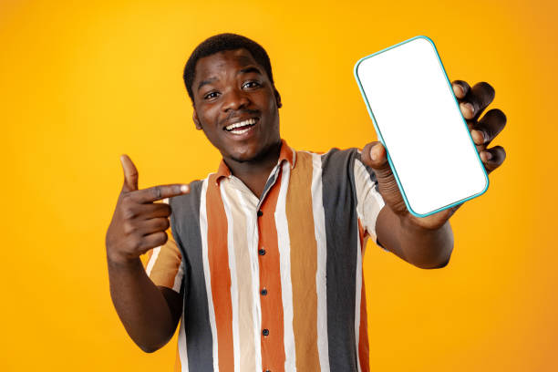 istock Young african man showing smartphone with isolated screen copy space 1785598143