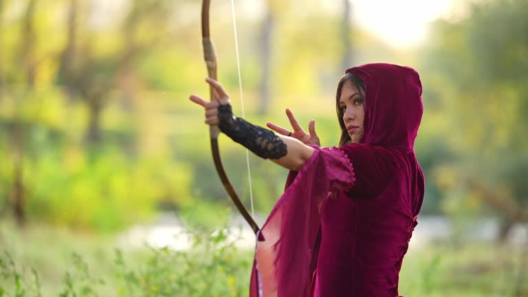 Magical Woman Firing The Arrow In The Forest