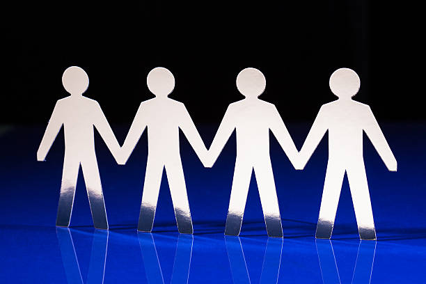 istock Silhouettes of people holding hands 178560359