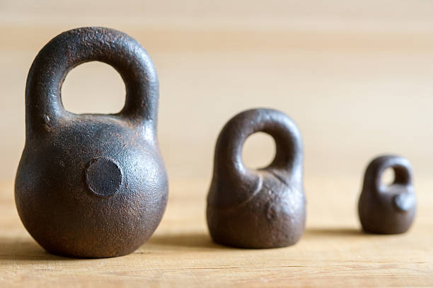 istock Three small calibration weights on wooden background. Slight DOF 178560922