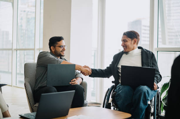 istock Disabled Businessman shaking hand in meeting. 1785609354
