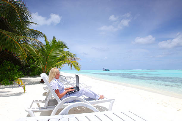 istock tropical business woman with laptop 178560988