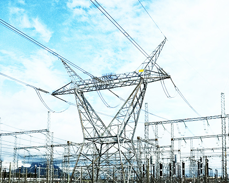 Steel giants rise into the sky, forming the backbone of the power grid, their interlinked cables and towers a testament to the complex network that electrifies our modern world. The power lines are distributing electricity from South Africa's only nuclear power station, Koeberg, north of Cape Town, which is nearby.