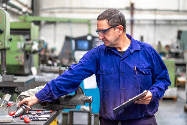 istock Factory worker operator in the numerical control sector making a report to send to suppliers, industrial factory 1785612052