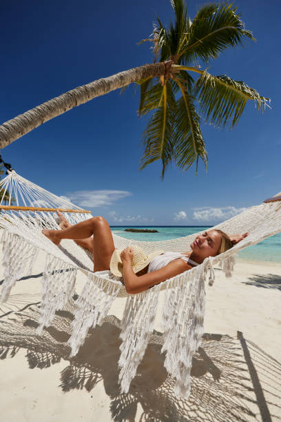 istock Smiling woman relaxing in hammock on the beach. 1785616934