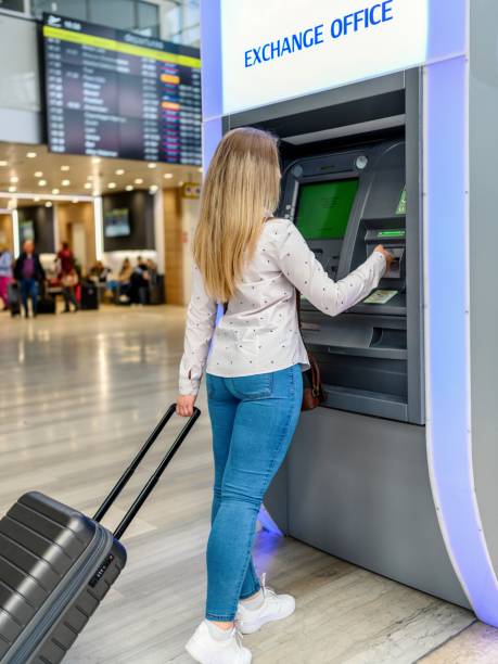 istock Tourist with a suitcase in front of an ATM 1785619081