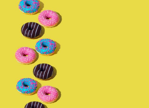 istock Creative arrangement of colorful donuts on light yellow background with copy space. Minimal food concept. Trendy yummy donuts idea. Donuts aesthetic background. 1785622366