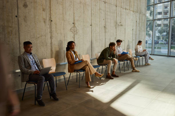 istock Group of candidates waiting for a job interview in a hallway. 1785625112