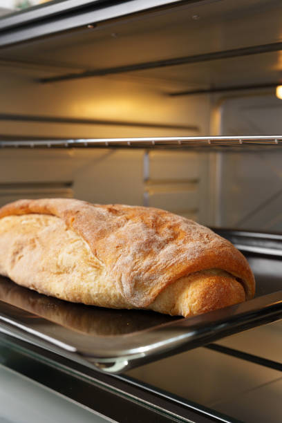 istock Freshly baked bread in mini oven in the kitchen 1785631607