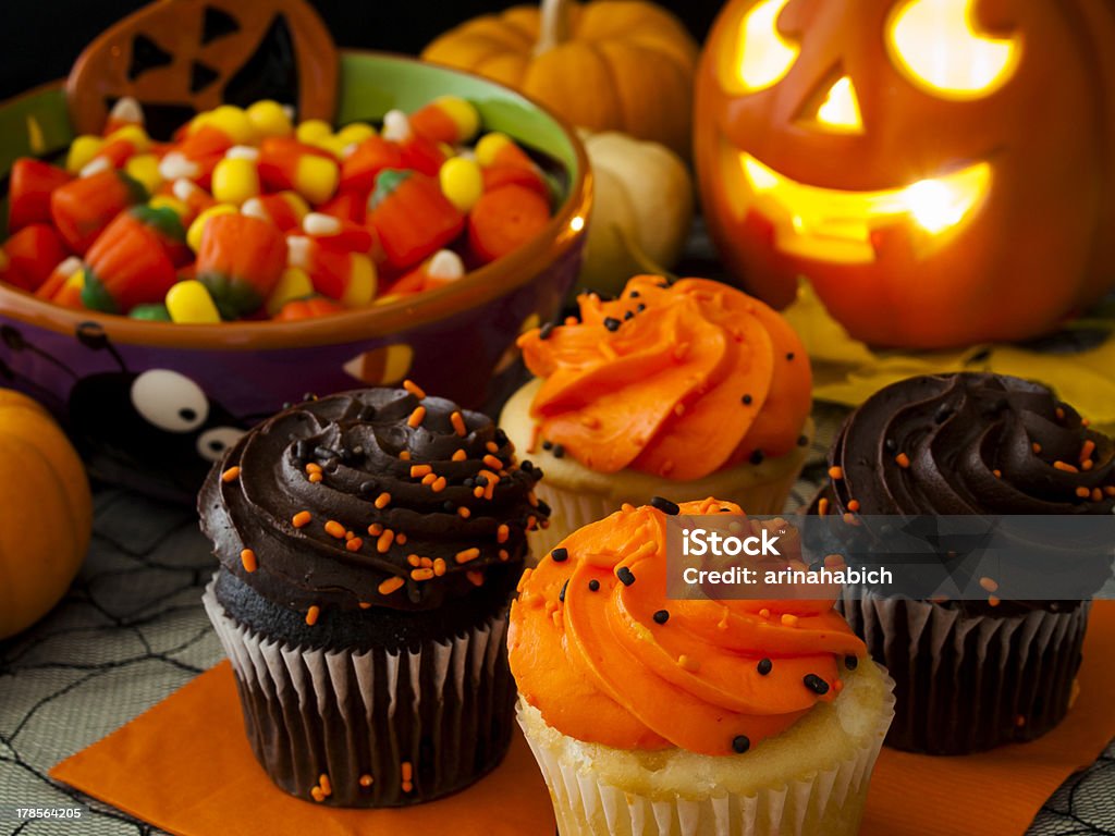 Halloween Cupcakes Halloween cupcakes with orange and black icing on orange napkin. Halloween Stock Photo