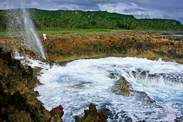 High Angle View Of Man Jumping From Cliff Into Sea