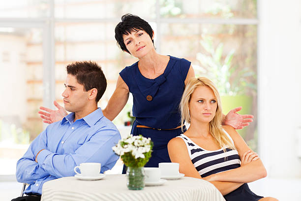 mother feeling helpless when caught in between middle aged mother feeling helpless when caught in between young couple's fight annoying mother in law stock pictures, royalty-free photos & images