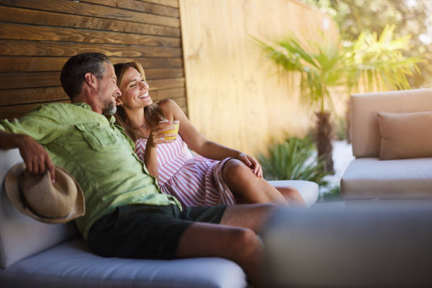 istock Happy couple enjoying in summer day on a patio. 1785648934
