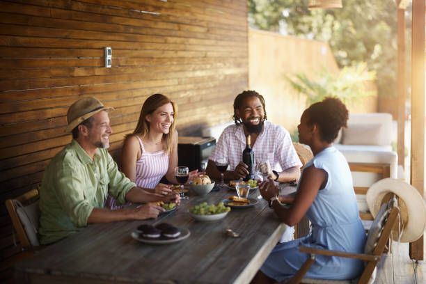 istock Happy diverse friends talking while drinking wine on a patio. 1785650017